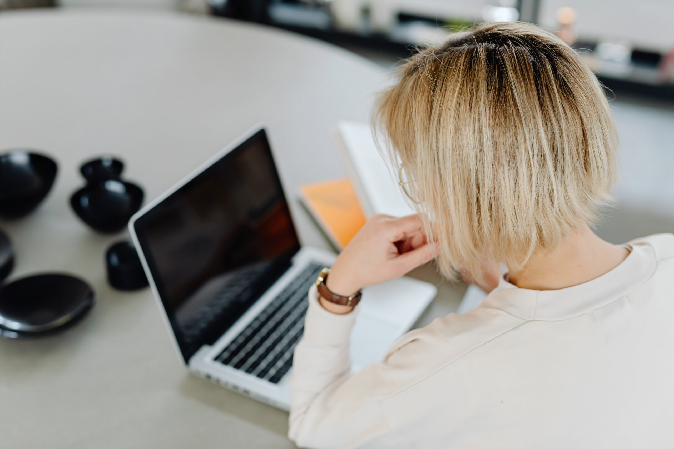 Woman working at computer screen — a common cause of digital eye strain